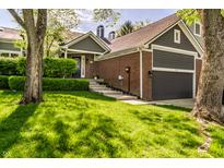 Charming brick home with an attached garage and meticulously landscaped front yard at 7849 Clearwater Cove Dr, Indianapolis, IN 46240