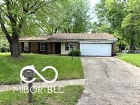 Charming single-story home with an attached garage and a well-maintained front lawn at 7916 Catawba Ct, Indianapolis, IN 46217