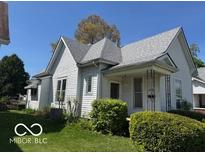 Charming two-story home features a well-maintained yard and classic architectural details at 113 1St St, Shelbyville, IN 46176