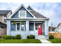 Charming home with a red door, grey painted brick porch, gray siding and well-maintained lawn at 1330 Marlowe Ave, Indianapolis, IN 46202
