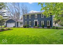 Charming two-story home with an expansive green lawn and well-maintained landscaping at 13363 Lantern Rd, Fishers, IN 46038