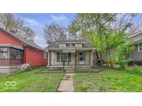 Charming home with a covered front porch and mature trees at 1529 E Gimber St, Indianapolis, IN 46203