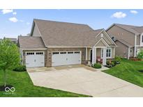 Lovely home with a spacious three-car garage, green lawn, and inviting curb appeal at 161 Tamarack Larch Blvd, Cicero, IN 46034