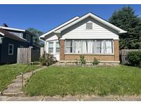 Charming bungalow featuring a brick facade, well-manicured lawn, and inviting curb appeal at 1622 S Randolph St, Indianapolis, IN 46203