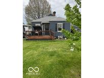 Charming home featuring a cozy front porch and well-manicured lawn at 1623 Oliver Ave, Indianapolis, IN 46221