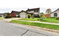 Charming two-story home with a well-manicured lawn and attached garage at 181 Tracy Ridge Blvd, Whiteland, IN 46184