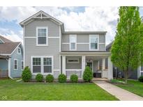 Charming two-story home with a well-manicured lawn and inviting front porch at 1909 Orange St, Indianapolis, IN 46203