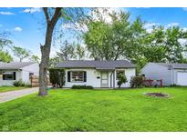Charming single-story home with a well-manicured lawn, fresh landscaping, and bright, natural light at 2307 Magnolia Pl, Indianapolis, IN 46219