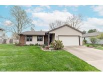 Charming home with a well-manicured lawn and an attached two-car garage at 3003 Foxpointe Dr, Columbus, IN 47203