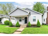 Charming home featuring a covered porch, tidy landscaping and freshly painted exterior at 319 S Randolph St, Indianapolis, IN 46201
