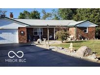 Charming single-story brick home with a well-maintained lawn and a white metal roof at 3348 W 800 N, Fairland, IN 46126