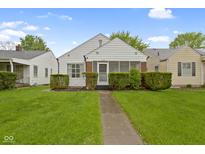 Charming home featuring lush green lawn, and decorative hedges enhance the curb appeal at 46 N Kitley Ave, Indianapolis, IN 46219