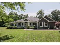 Charming single-story home with a welcoming front porch and well-manicured lawn at 5607 E 500 N, Greenfield, IN 46140