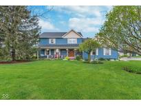 Charming two-story home with a covered porch and a well-manicured lawn at 7020 N 375 E, Lebanon, IN 46052