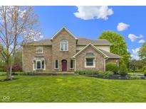 Charming two-story brick home with a well-manicured lawn and inviting red front door at 960 Arrowwood Dr, Carmel, IN 46033