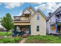 Charming two-story home with a cozy front porch and an inviting second-floor balcony at 1121 Eugene St, Indianapolis, IN 46208