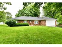 Charming brick ranch home with an attached garage and lush green lawn at 12087 N Gasburg Rd, Mooresville, IN 46158