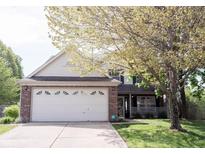 Charming two-story home with a brick facade, a two-car garage, and a well-manicured lawn at 14153 Jasmine Ct, Fishers, IN 46038