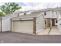 View of the attached garage with brick accents, matching the home's exterior at 162 Carmelaire Dr, Carmel, IN 46032