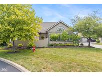 Charming home featuring well-manicured lawn, mature trees, and stone accents create inviting curb appeal at 16637 Brownstone Ct, Westfield, IN 46074