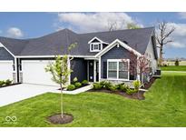 Charming home featuring dark siding, white trim, dormer window, landscaped front yard and attached garage at 19437 Astoria Ave, Sheridan, IN 46069