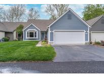 Charming single-Gathering home with a two-car garage and a well-manicured lawn and flowerbeds at 3136 River Bay N Dr, Indianapolis, IN 46240