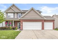 Charming two-story brick home with a two-car garage and manicured landscaping at 4264 Amesbury Pl, Noblesville, IN 46062