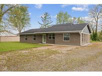 Charming single story brick home with a gravel driveway and a well-maintained lawn and tidy landscaping at 5168 E Walnut Dr, Mooresville, IN 46158