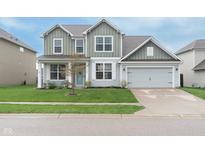 Charming two-story home featuring a well-manicured lawn, attached two-car garage, and a welcoming covered front porch at 6164 Brighton Dr, Whitestown, IN 46075
