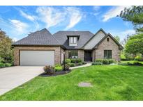 Charming brick home featuring a well-manicured lawn and a two-car garage at 621 Thorne Dr, Brownsburg, IN 46112