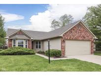 Charming single-story home with brick accents, a well-manicured lawn, and an attached two-car garage at 6337 Whitaker Farms Dr, Indianapolis, IN 46237