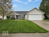 Charming single-story home features a well-maintained lawn and a two-car garage at 7108 Burlat Ln, Noblesville, IN 46062