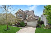 Charming two-story home featuring neutral siding, a two-car garage, and a cozy front porch at 7824 Gray Eagle Dr, Zionsville, IN 46077