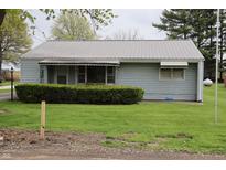 Charming single-story home featuring light blue siding and well-maintained landscaping at 8341 N Washington St, Sheridan, IN 46069