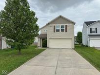 Inviting two-story home with a well-maintained front yard and a two-car attached garage at 8409 Bolero Way, Camby, IN 46113