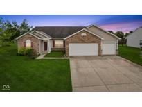 Charming single-story home with brick accents, two-car garage, and well-manicured lawn at 901 Palomino Pl, Bargersville, IN 46106