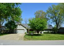 Charming single-story home featuring an attached garage, inviting curb appeal, and mature trees at 931 Beech Dr, Greenwood, IN 46142