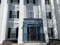 The Fordham House features a blue door, black shutters, and beautiful architectural pillars at 12873 Tradd St # 2B, Carmel, IN 46032