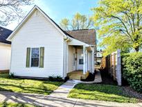 Charming home with front porch and well-maintained lawn and inviting walkway at 1303 9Th St, Columbus, IN 47201