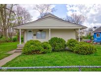 Charming single-story home features a cozy front porch and well-maintained landscaping at 1467 W 33Rd St, Indianapolis, IN 46208