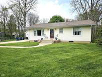 Charming one-story home with a well-manicured lawn, walkway, and inviting front entrance at 1506 Field Dr, Noblesville, IN 46060