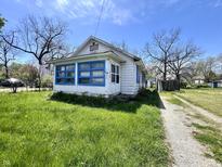A quaint single story home with blue trim and a stone path at 1525 Home Ave, Anderson, IN 46016