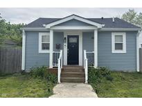 Charming blue house with a black front door and white trim, offering a welcoming entrance at 1641 Iowa St, Indianapolis, IN 46203