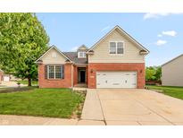 Charming two-story home featuring a red brick facade, attached two-car garage, and well-manicured lawn at 18680 Long Walk Ln, Noblesville, IN 46060