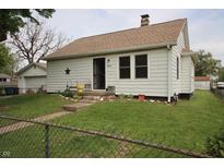 Charming home with white siding, a star decoration, and a chain link fence at 2657 Mars Hill St, Indianapolis, IN 46241