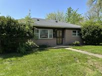 Charming single story home with manicured lawn and brick facade at 2842 Sangster Ave, Indianapolis, IN 46218