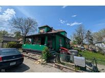 View of home with covered porch needing repair and a car parked out front at 3602 E 22Nd St, Indianapolis, IN 46218