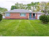 Charming brick ranch-style home with a well-manicured lawn and neatly trimmed bushes at 4029 N Euclid Ave, Indianapolis, IN 46226
