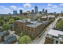 Stunning aerial view of the building with a city skyline backdrop on a partly cloudy day at 430 N Park Ave # 103, Indianapolis, IN 46202