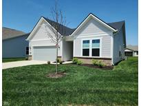 Charming one-story home featuring a well-manicured lawn, attached garage, and stylish white siding at 4734 Cleome Dr, Plainfield, IN 46168